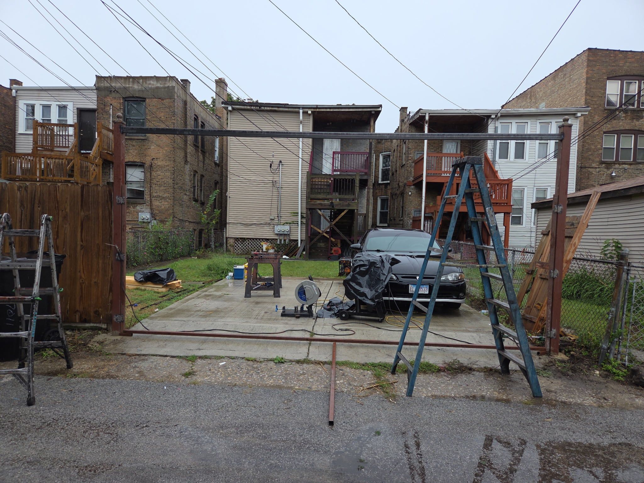 Alley parking pad with the new steel gate posts and header going in
