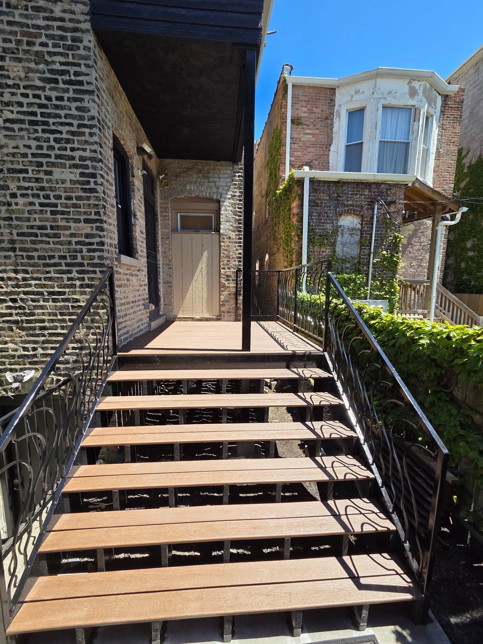 Looking up the new front steps and scrolled iron railings to the entry