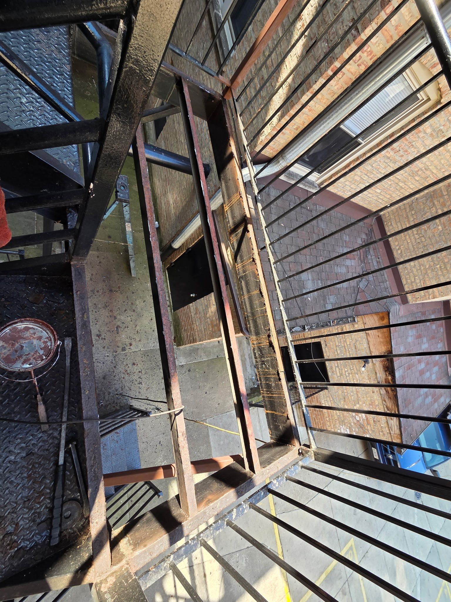 Looking down the new steel stair frame and railings during construction