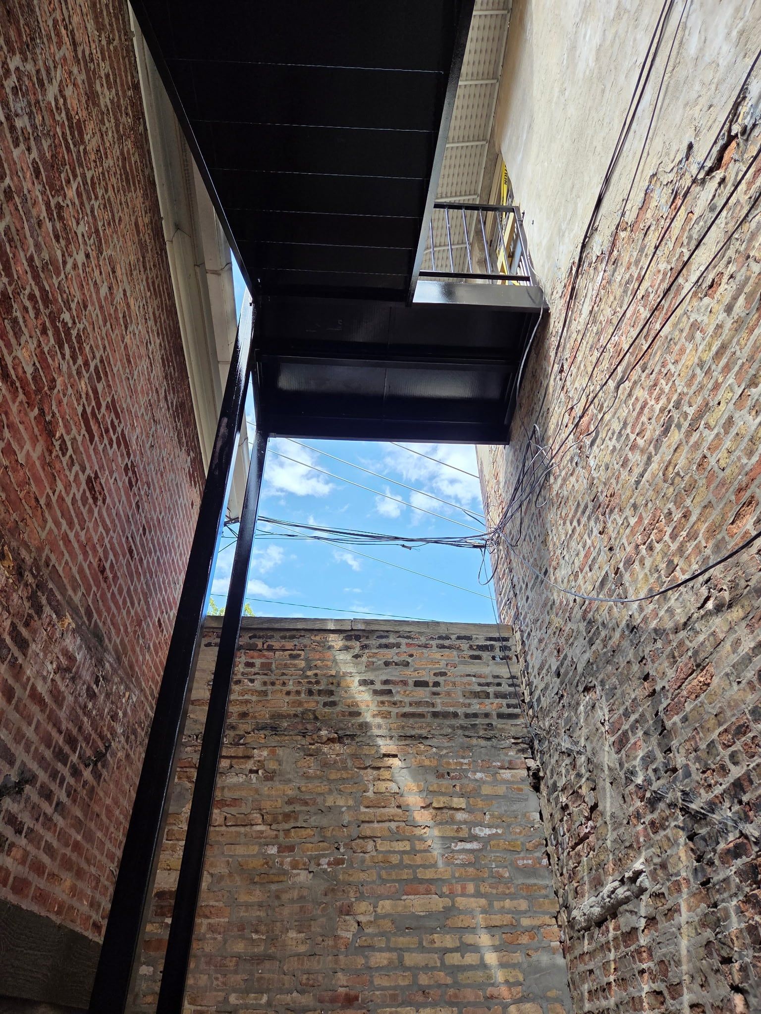 View from below of the steel landing and stair framing